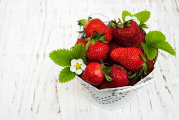 Metal pot with strawberries