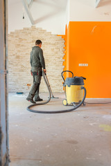 Man Vacuuming a Construction Site