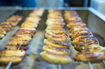 Delicious barbecue bananas on skewers in Bangkok street food stall, Thailand