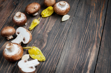 Top view of mushrooms and pepper on wooden background