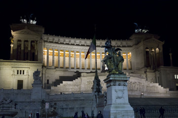 Fototapeta na wymiar The Altar of the Fatherland, also known as National Monument to Victor Emmanuel II, lighted at night in Rome, with its equestrian statue in the middle