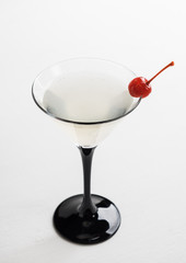 Cocktail in martini glass on the white wooden background
