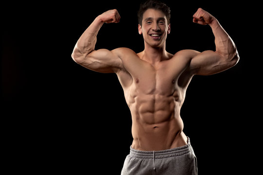 Muscular toung man on a black background