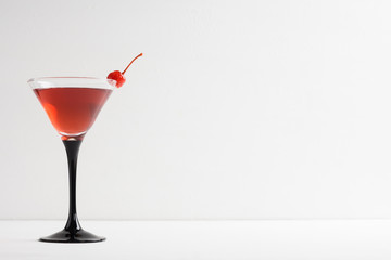 Cocktail in martini glass on thewhite  wooden background