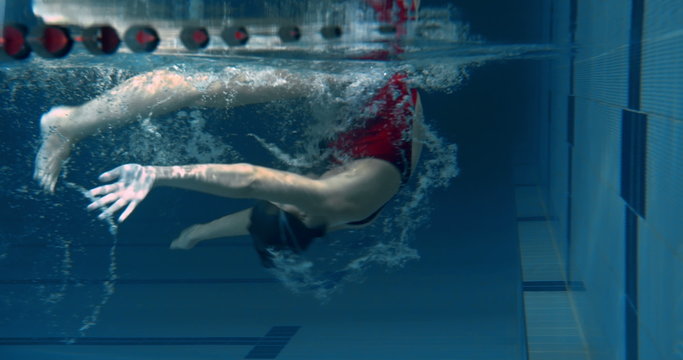 Underwater view of woman performing a flip turn in the swimming pool