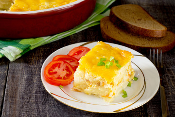 Baked potatoes with cheese and fish fillets in a rustic style