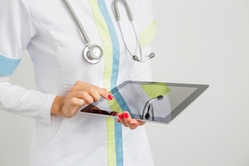 Medical worker with stethoscope and tablet 