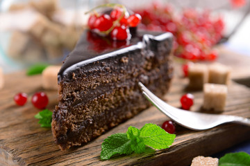 Tasty chocolate cake with berries on table close up