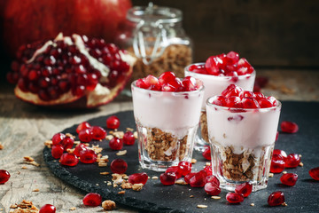 Breakfast with baked muesli, yoghurt and pomegranate, portioned
