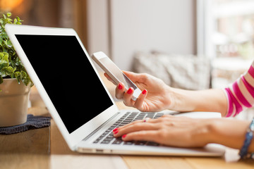 Woman with computer and cellphone 