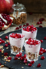 Breakfast with baked muesli, yoghurt and pomegranate, portioned