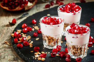 Breakfast with baked muesli, yoghurt and pomegranate, portioned