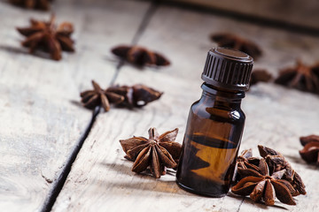 Essential oil of anise in a small brown bottle, selective focus