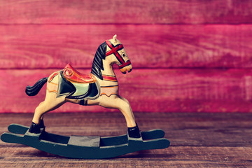 old toy horse on a wooden surface
