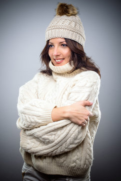 Smiling young woman in a knitted winter outfit