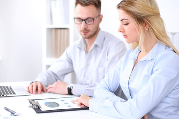 Two successful business partners working at meeting in office