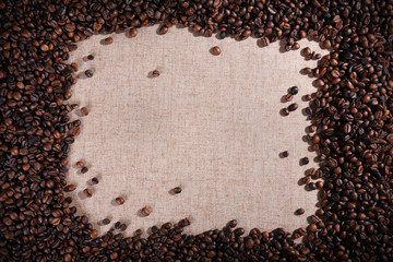 Frame of roasted coffee beans on the linen fabric