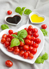 Snack tomatoes, basil, oil and vinegar to make a healthy salad
