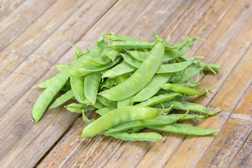 Green peas on a bamboo background