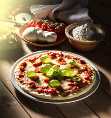 Pizza with tomatoes mozzarella and basil on the wooden table