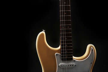 Obraz premium Part of white electric guitar, on black background