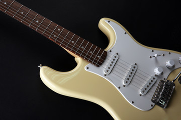 White electric guitar, on black background