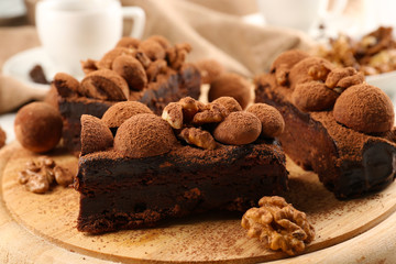 A piece of chocolate cake with walnut on the table, close-up