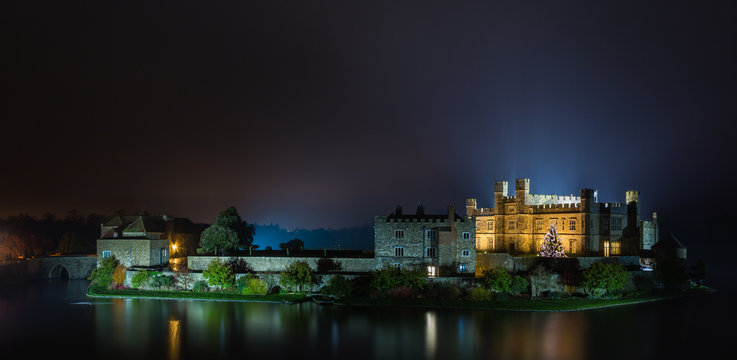 English castle with Christmas lights at night