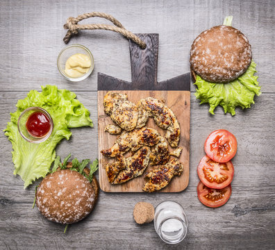 Chicken Grilled With Mustard Sauce With Ingredients For Homemade Burger, Vegetables And Spices On Wooden Rustic Background Top View