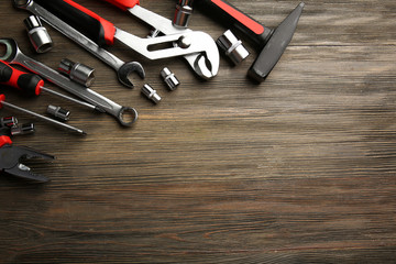 Fototapeta premium Different kinds of tools on wooden background, top view