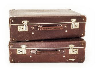 Two vintage suitcases on white background
