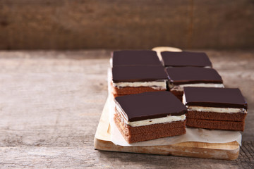 Delicious chocolate brownies on wooden background