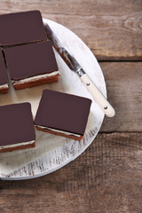 Delicious chocolate brownies on wooden background