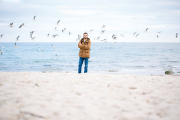 Man standing with arms folded at the beach