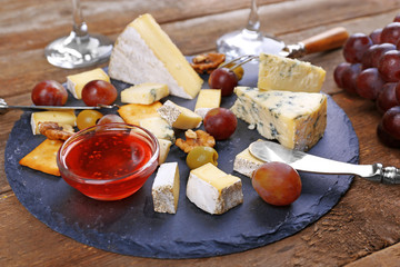 Cheese for tasting on wooden table, closeup