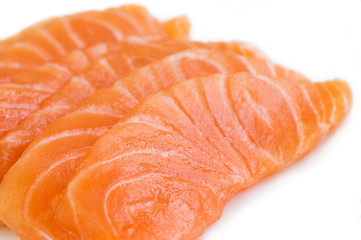 Sliced raw salmon isolated on white background