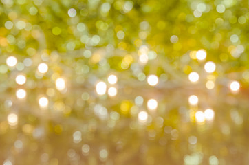 Gold glittering christmas lights. Blurred abstract background