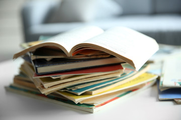 Pile of old books on white table, close up