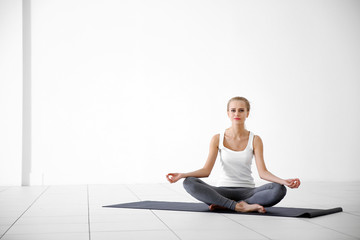 Fototapeta premium Young woman do yoga exercise - meditation