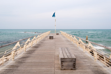Empty pier with benches on the sea in Pesaro