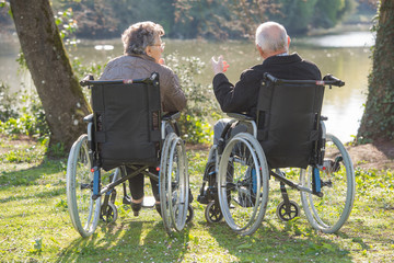 Couple in wheelchairs, looking at the view