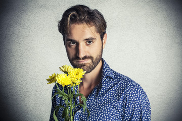 Romantic boy holding a bunch of flowers