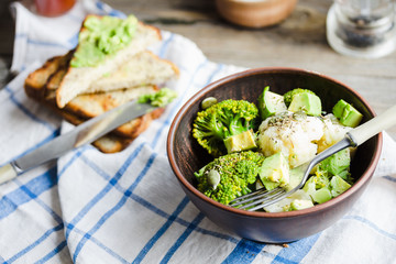 Winter vegetable salad with broccoli and cauliflower, toast with