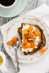 sweet toast with caramelized pumpkin, cheese and nuts, top view