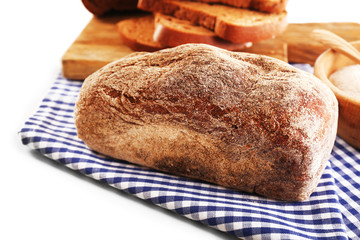 Sliced bread with ears and flour on napkin isolated on white