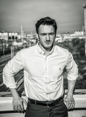 Handsome young man outside wearing white shirt