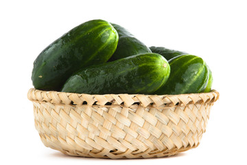 cucumbers in basket on white