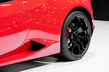 Detail of the back wheel of a red car