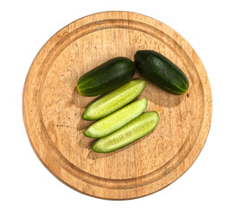 cucumbers on wooden cutting board