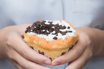 Woman holding beautiful cupcake, close up